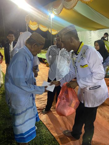 Kades Padengo Saat Membagikan Sembako Kepada Masyarakat (F/Istimewah).
